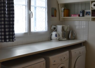 Utility room with washing machine and dryer in holiday home in France